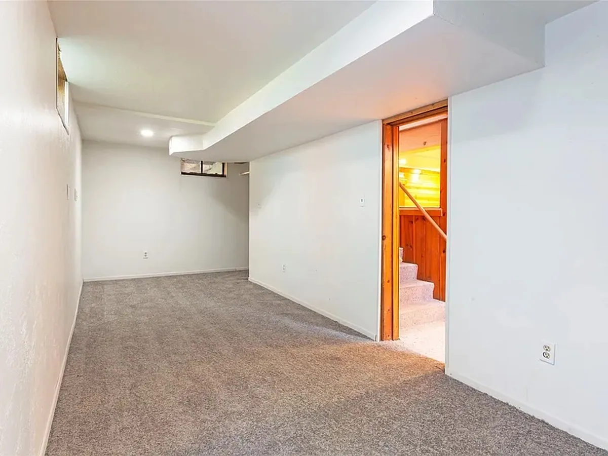Lower-level bedroom with new carpet and fresh paint