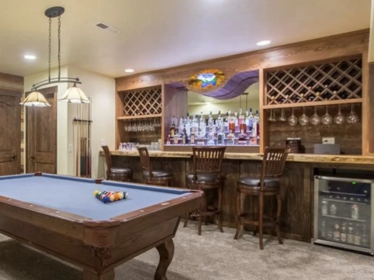Custom barnwood basement bar with wine lattice storage and a live-edge counter
